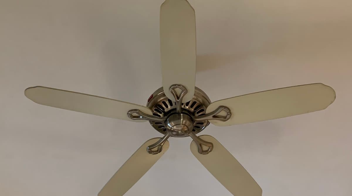 Five-blade ceiling fan with brushed nickel motor mounted on a white ceiling