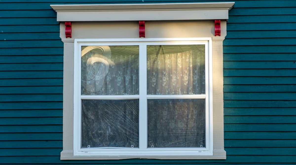 New double-hung vinyl replacement windows installed in a home exterior